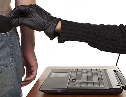 A gloved hand reaches out of a laptop screen and steals a wallet from the back pocket of a man's trousers.