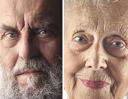 A man and a women of different ages looking directly into camera.